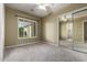 Neutral bedroom featuring carpet, window shutters, ceiling fan, and mirrored closet doors at 3531 E Norwood Cir, Mesa, AZ 85213