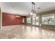 Open dining area with stone floors, modern light fixture, and bright windows for natural lighting at 3531 E Norwood Cir, Mesa, AZ 85213