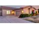 Charming home exterior featuring a multi-car garage, well-maintained lawn, and vibrant, colorful landscaping at 3531 E Norwood Cir, Mesa, AZ 85213