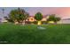 Well-manicured lawn and mature landscaping highlight this single-story home's curb appeal at 3531 E Norwood Cir, Mesa, AZ 85213