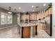 Spacious kitchen with island, custom cabinets, granite countertops, stainless steel appliances, and travertine flooring at 3531 E Norwood Cir, Mesa, AZ 85213