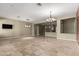 Expansive living space with travertine floors and modern lighting fixtures, perfect for entertaining guests at 3531 E Norwood Cir, Mesa, AZ 85213