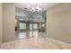 Glass-enclosed office space featuring travertine flooring and clear views into other living areas at 3531 E Norwood Cir, Mesa, AZ 85213