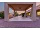 Covered patio with a ceiling fan overlooking a sparkling pool at dusk at 3531 E Norwood Cir, Mesa, AZ 85213