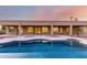Backyard pool view reflecting home and gorgeous sunset in still blue water at 3531 E Norwood Cir, Mesa, AZ 85213