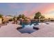 Beautiful in-ground pool with stone features, surrounded by lush landscaping at 3531 E Norwood Cir, Mesa, AZ 85213