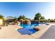 Inviting in-ground pool with blue water, rock accents, and lush landscaping at 3531 E Norwood Cir, Mesa, AZ 85213