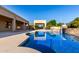 Beautiful backyard pool featuring cool blue water, a stone waterfall, and a covered patio area for outdoor relaxation at 3531 E Norwood Cir, Mesa, AZ 85213