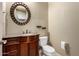 Charming powder room with a granite countertop, vessel sink, bronze fixtures and matching mirror at 3531 E Norwood Cir, Mesa, AZ 85213