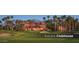 Tuscany Clubhouse on a pristine golf course, surrounded by lush landscaping and palm trees at 3566 N 166Th Dr, Goodyear, AZ 85395