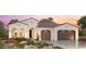 Elegant, single story home with a terracotta roof, a lush front yard, and a convenient two-car garage at 3566 N 166Th Dr, Goodyear, AZ 85395