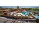Overhead shot of the resort-style pool complex with ample seating and lush landscaping at 3566 N 166Th Dr, Goodyear, AZ 85395