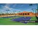 View of the lighted tennis courts, ready for evening play in the community at 3566 N 166Th Dr, Goodyear, AZ 85395