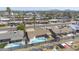Aerial view featuring a home with a backyard pool, carport, and lush neighborhood surroundings at 3823 W Rose Ln, Phoenix, AZ 85019