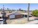 Aerial view showcasing a charming home with a covered carport and mature palm trees at 3823 W Rose Ln, Phoenix, AZ 85019