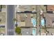 Top-down aerial view of a home with a pool, carport, and close proximity to neighborhood amenities at 3823 W Rose Ln, Phoenix, AZ 85019
