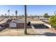 Cozy one-story home with brick exterior and carport, enhanced by mature palm trees in a desert landscape at 3823 W Rose Ln, Phoenix, AZ 85019