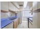 Traditional-style kitchen featuring blue countertops, white cabinets, and modern appliances at 3823 W Rose Ln, Phoenix, AZ 85019