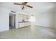 Open concept living room featuring neutral-toned walls and ceilings, with access to the kitchen at 3823 W Rose Ln, Phoenix, AZ 85019