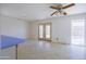 Bright living room with backyard pool view and ceiling fan at 3823 W Rose Ln, Phoenix, AZ 85019