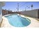 Backyard showcasing a sparkling swimming pool surrounded by a concrete patio at 3823 W Rose Ln, Phoenix, AZ 85019