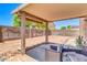 Covered backyard patio with seating, perfect for outdoor entertaining at 40638 N High Meadows Dr, San Tan Valley, AZ 85140
