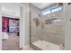 Modern bathroom with tiled shower, glass door, and built-in shelving at 40638 N High Meadows Dr, San Tan Valley, AZ 85140