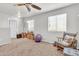 Spacious bedroom with carpet, a rocking chair, and multiple windows at 40638 N High Meadows Dr, San Tan Valley, AZ 85140