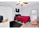 Bedroom with plush red bedding, a ceiling fan, and sliding closet doors at 40638 N High Meadows Dr, San Tan Valley, AZ 85140