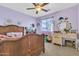 Bedroom featuring a wooden bedframe, vanity, and light purple walls with charming decorations at 40638 N High Meadows Dr, San Tan Valley, AZ 85140