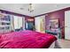 Charming bedroom featuring a dresser with a television, sliding door and a chandelier at 40638 N High Meadows Dr, San Tan Valley, AZ 85140
