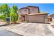 Two-story home featuring a two-car garage, a well-manicured lawn, and a charming front porch at 40638 N High Meadows Dr, San Tan Valley, AZ 85140