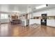 Kitchen with stainless steel appliances, hardwood floors, and abundant white cabinetry at 40638 N High Meadows Dr, San Tan Valley, AZ 85140