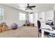 Bright living room with carpet, a ceiling fan and a reading nook with a chair at 40638 N High Meadows Dr, San Tan Valley, AZ 85140