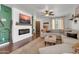 Bright living room featuring a comfortable sofa, a ceiling fan, and an electric fireplace with TV at 40638 N High Meadows Dr, San Tan Valley, AZ 85140