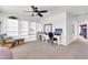 Spacious living room featuring a ceiling fan, built-in shelves, and bright, neutral walls at 40638 N High Meadows Dr, San Tan Valley, AZ 85140