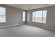 A large, well-lit bedroom featuring neutral paint, carpet floors, recessed lighting, and two large windows at 4227 W Adobe Dr, Eloy, AZ 85131