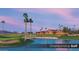Scenic golf course view with water feature, manicured greens, and palm trees under a blue sky at 4227 W Adobe Dr, Eloy, AZ 85131