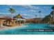 Resort-style pool complex featuring sparkling water, shaded seating areas, and lush landscaping at 4227 W Adobe Dr, Eloy, AZ 85131