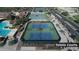 Aerial view of lighted tennis courts with lush landscaping at 4227 W Adobe Dr, Eloy, AZ 85131
