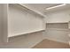Walk-in closet with white walls, carpet floor, overhead lighting, and built-in white shelves and clothing rods at 4227 W Adobe Dr, Eloy, AZ 85131