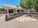 Rear covered patio with flagstone details; a gravel yard and block wall fencing at 4332 E Stanford Ave, Gilbert, AZ 85234