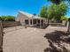Backyard with gravel landscaping, covered patio, block wall fencing and well established trees at 4332 E Stanford Ave, Gilbert, AZ 85234