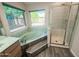 Bright bathroom featuring a garden tub, a separate shower, and dual windows overlooking the yard at 4332 E Stanford Ave, Gilbert, AZ 85234