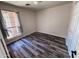 Bedroom featuring wood-look floors, a window with curtains, and a closet at 4332 E Stanford Ave, Gilbert, AZ 85234