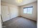 Bedroom featuring carpeted floors, a window offering a view of the yard, and a closet at 4332 E Stanford Ave, Gilbert, AZ 85234