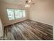 Bright bedroom featuring wood-look flooring and a large window providing plenty of natural light at 4332 E Stanford Ave, Gilbert, AZ 85234