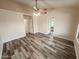 Spacious bedroom featuring wood-look flooring, a ceiling fan, and access to other rooms at 4332 E Stanford Ave, Gilbert, AZ 85234