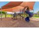 Community playground with a sunshade and multiple pieces of play equipment at 4332 E Stanford Ave, Gilbert, AZ 85234