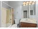 A well-lit bathroom featuring a shower-tub combo, toilet, and a vanity with a mirror at 43502 W Kramer Ln, Maricopa, AZ 85138